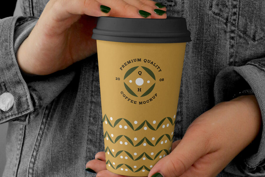 person holding branded coffee cups