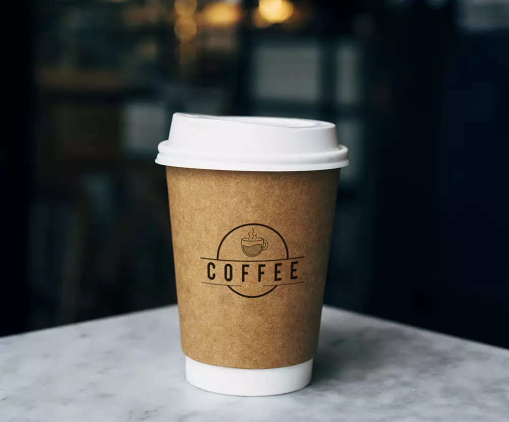 single coffee cup with branded paper