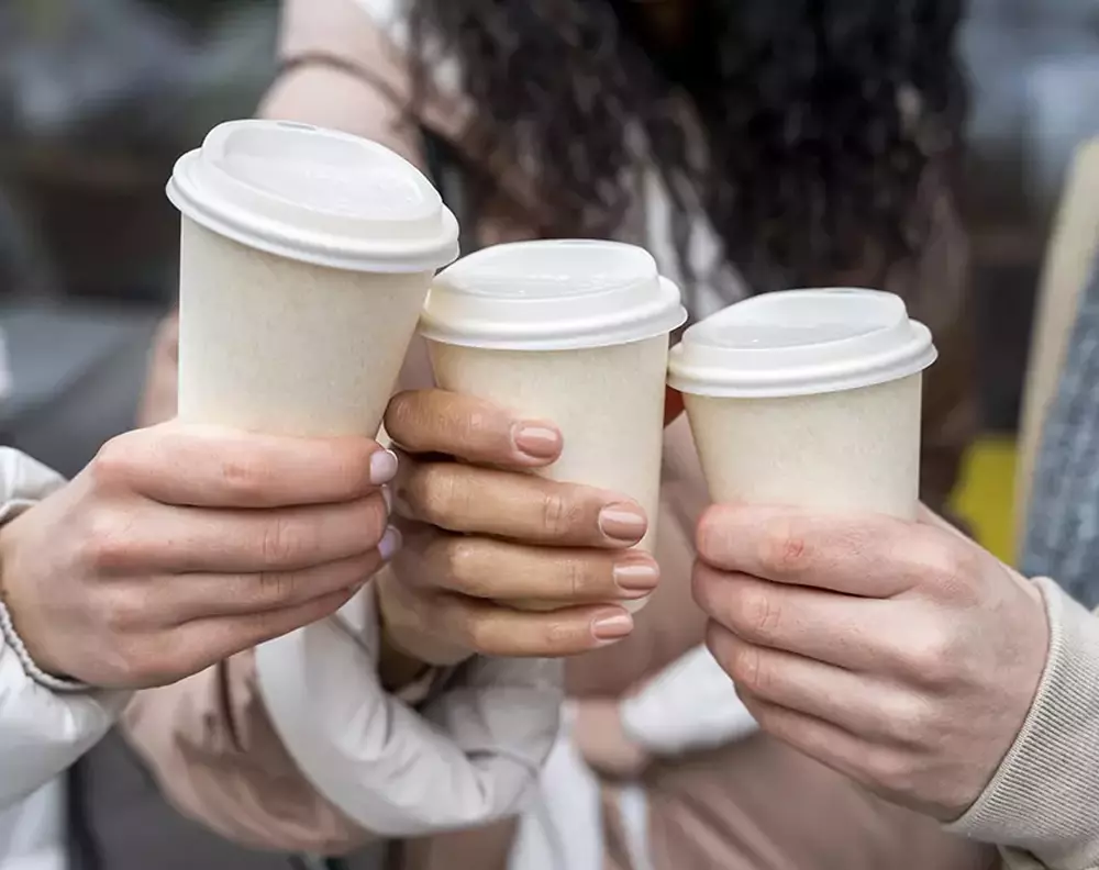 people holding coffee cups